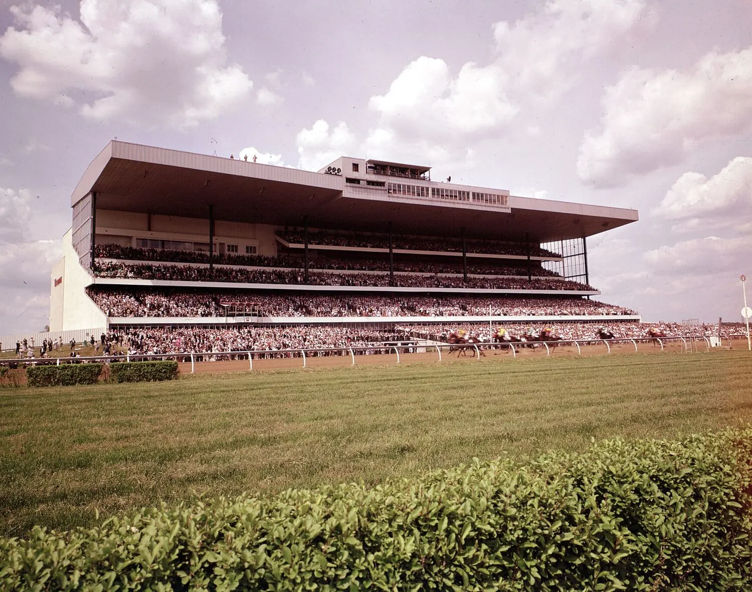 The Woodbine grandstand photographed from the infield in its early years, with a full crowd on all three decks