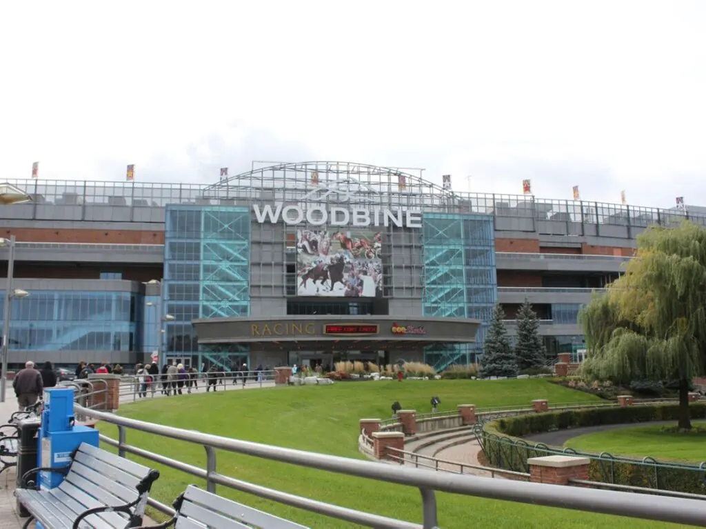 The Woodbine complex seen from the landscaped entrance lawn, with glass frontage and the grandstand roofline